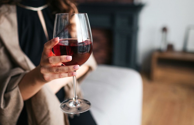 woman holding a glass of red wine