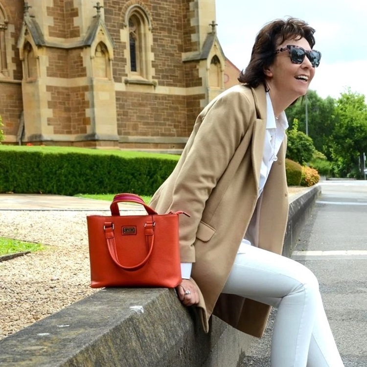 women wearing red bag 