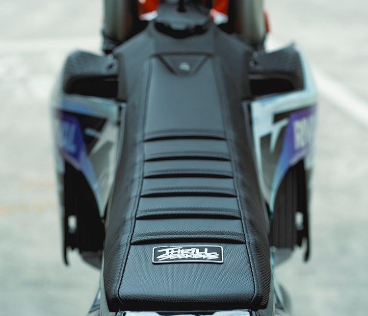 A close-up shot of a motocross bike seat, showcasing a sleek and rugged bike seat cover designed for optimal grip and comfort.