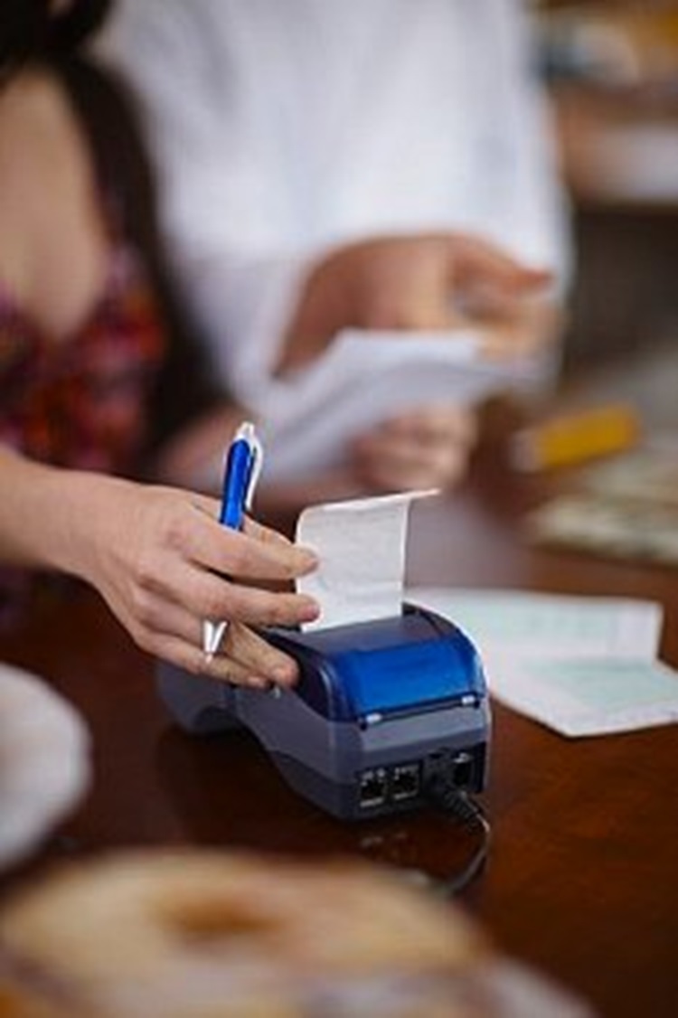 woman using receipt printer 