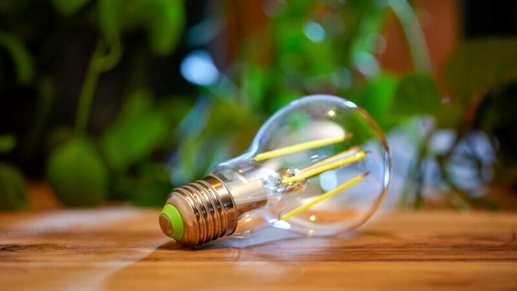 a led light bulb sitting on top of a wooden table